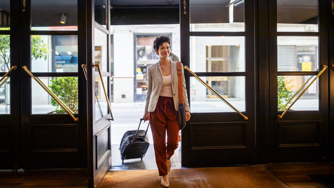 female-business-traveler-arriving-at-hotel